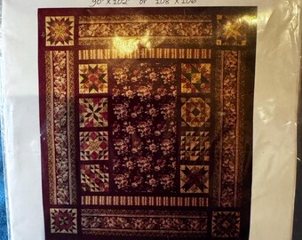 May include: A quilt pattern titled "MARGRETA" with dimensions of 90" x 102" or 108" x 106". The quilt features a floral design in shades of burgundy, cream, and gold. The quilt is from "The QUILT HAUS".