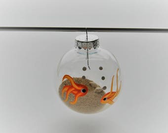 Hand Painted fish on sand and shell filled plastic ornament