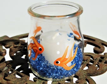 Hand Painted (gold fish) glass votive with blue glass chips and candle included