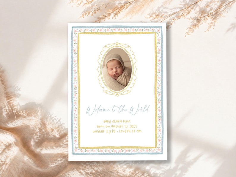 May include: A baby announcement card with a photo of a newborn in a bonnet. The card has a blue and gold floral border and the text "Welcome to the World." The baby's weight is 5.0 kg and length is 49 cm.