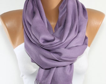 May include: A soft, purple pashmina scarf with fringe. The scarf is draped around a mannequin's neck.