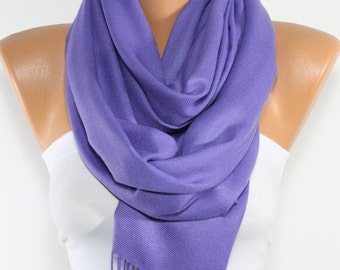 May include: A soft purple pashmina scarf with fringe on the ends. The scarf is draped around a mannequin's neck.