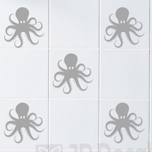 May include: Grey octopus decals on white square tiles. The octopus design is repeated across the tiles, creating a pattern. Two white bottles sit on a glass shelf, adding a decorative touch.