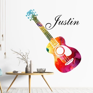 May include: A colourful watercolour guitar decal with the name "Justin" written in a cursive font. The guitar is a light yellow, orange, red, and purple colour.