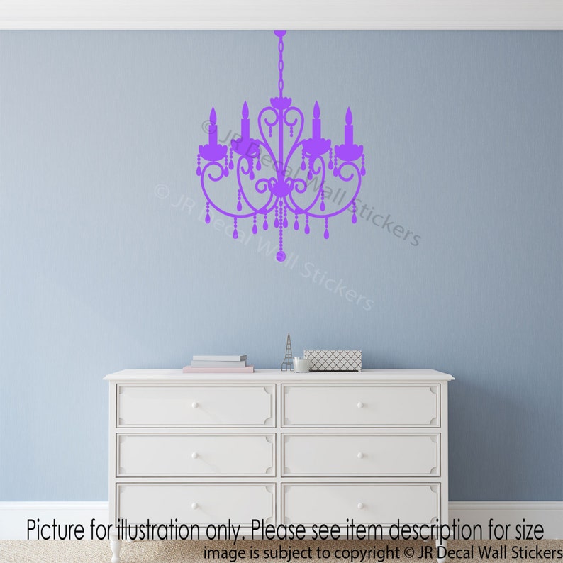 May include: Purple chandelier wall decal. The decal is shown on a light blue wall above a white dresser.