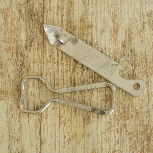 May include: Two vintage metal bottle openers. One is a standard bottle opener with a loop handle and the other is a Schlitz beer opener with a pointed end and a Schlitz logo.