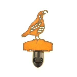 May include: A metal night light featuring a cut-out silhouette of a quail perched on a small platform. The night light is painted in a bright orange color.