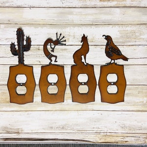 May include: Set of four metal light switch covers featuring Southwestern designs. The covers are rusty brown and feature a cactus, a Kokopelli, a coyote, and a quail.