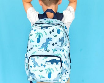 May include: A blue backpack with a dinosaur print. The backpack has a large pocket on the front and a smaller pocket on the side. The backpack is made of a durable material and is perfect for carrying books, supplies, and other essentials.