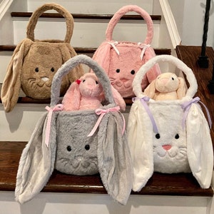 May include: Four plush bunny-shaped Easter baskets with long floppy ears. The baskets are brown, pink, gray, and white. Each basket has a small plush bunny inside.