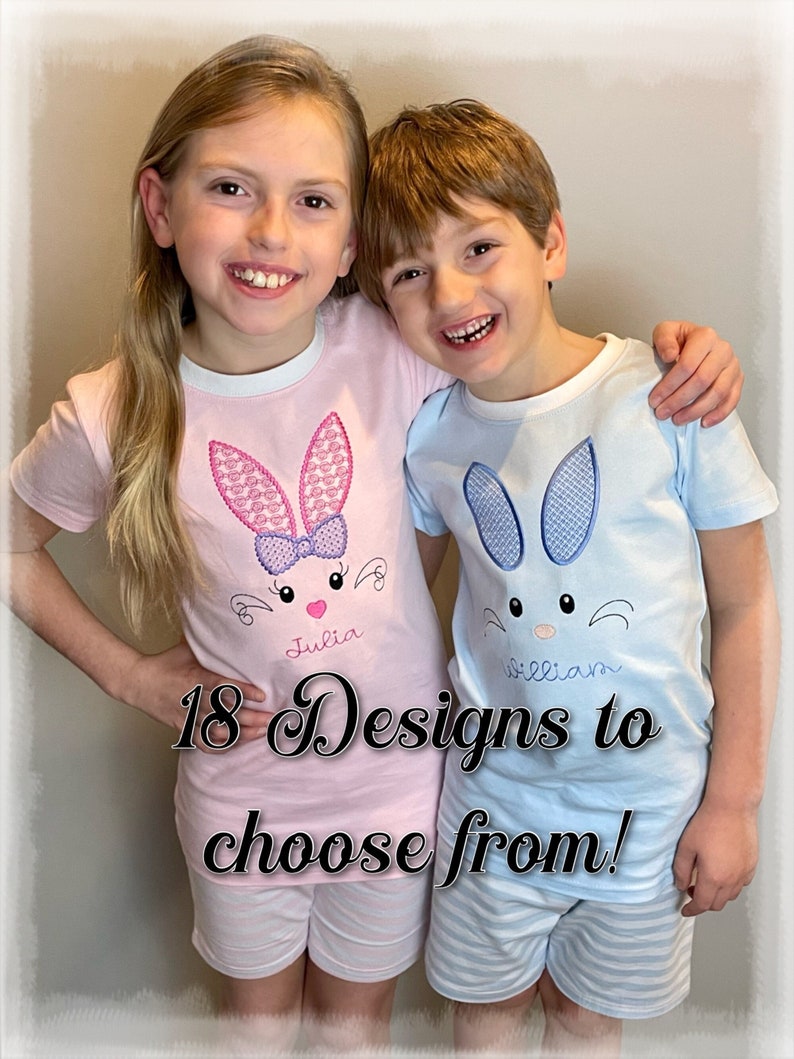 May include: Two children wearing matching pajamas with bunny embroidery. The girl's pajamas are pink with a pink bunny and the boy's pajamas are blue with a blue bunny. The pajamas are personalized with the names "Julia" and "William". 18 Designs to choose from!