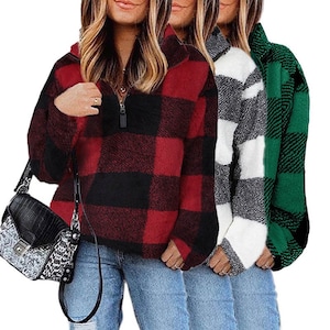May include: Three long-sleeved shirts with a plaid pattern. The shirts are red and black, white and gray, and green and black. The shirts have a quarter-zip closure.
