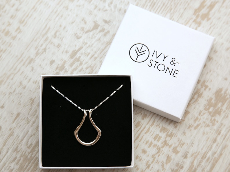 A beautiful Horseshoe Ring Holder Pendant Necklace in available Sterling Silver, 18K Yellow and Rose Gold Vermeil. This ring keeper is available a variety of lengths.