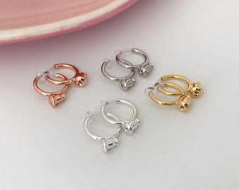 Round hoop ear clip converters in steel, silver, rose gold, and gold. Adapters for pierced earrings to convert hoops into clips.