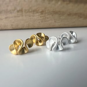 Invisible clip-on earrings, buttercream flower design, gold/silver, comfortable minimalist everyday wear.