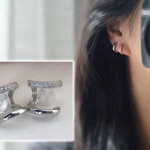 PAINLESS! U-shaped spiral clip-on earrings with double circles in silver with a mini zircon stone. Comfortable ear clips with delicate earrings.