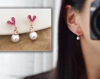 Kleine rosa Herz-Ohrclips, kleine weiße Perle in Roségold. Moderner Alltagsschmuck. Unsichtbare Ohrclips
