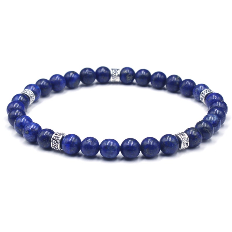 May include: A blue gemstone beaded bracelet with silver accents. The bracelet is made of small, round beads and has a simple, elegant design.