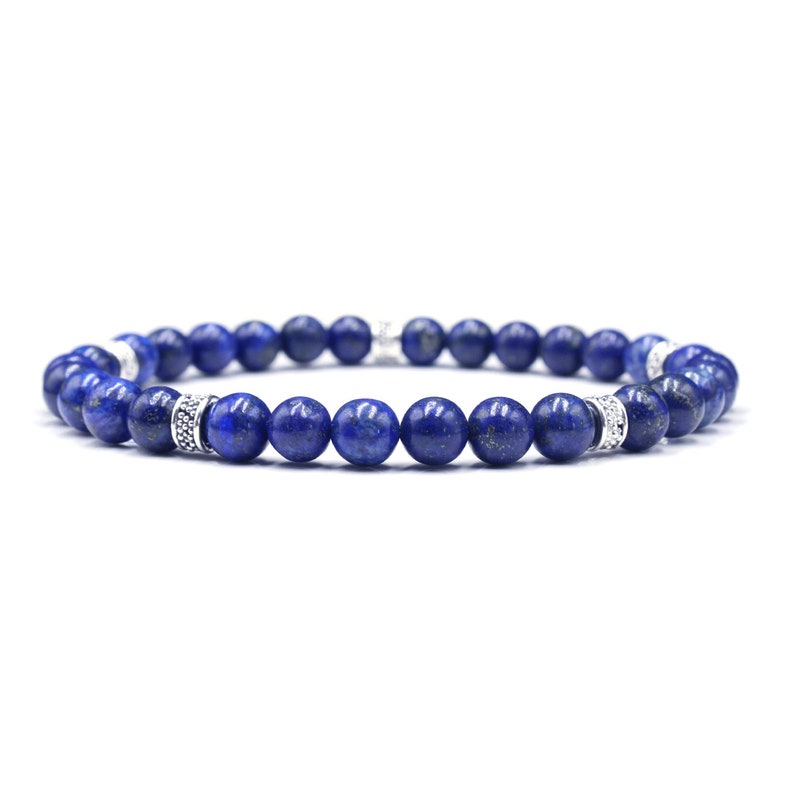 May include: A blue gemstone bracelet with silver accents. The bracelet is made of round beads and has a simple design.