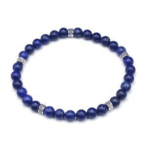 May include: A blue lapis lazuli beaded bracelet with silver accents. The bracelet is made of round beads and has a simple design.