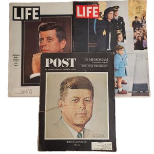 May include: Three vintage magazines including two LIFE issues and one Saturday Evening Post. The LIFE covers feature John F. Kennedy and a memorial scene. The Post cover displays a portrait of John F. Kennedy with the text In Memoriam.
