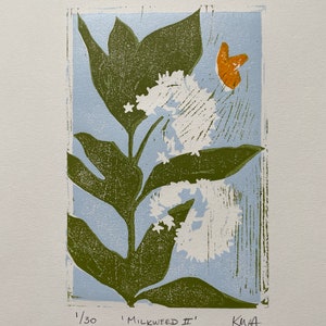 May include: A botanical print titled "Milkweed II" featuring a stylized milkweed plant with green leaves, white flowers, and an orange butterfly against a light blue background. The print is numbered 1/30 and signed by the artist.