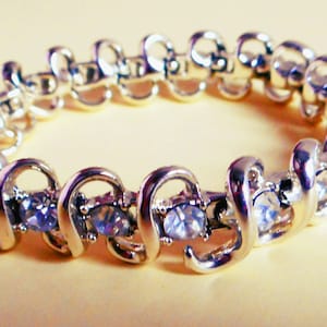 Superb 1950&#39;s Vintage CORO Rhinestone MCM Bracelet, clear crystals in modern swirly gold tone setting, mid century modern, stylish, signed