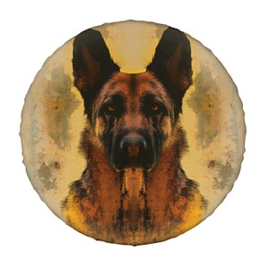 May include: Round decorative pillow featuring a German Shepherd dog. The dog's face is centered, with a detailed depiction of its fur in shades of brown, black, and tan. The background has a soft, yellow-toned, circular design.