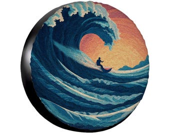 May include: Circular art piece depicting a surfer riding a large ocean wave. The wave is a deep blue with white foam, and the sky is a warm orange and yellow. A black border surrounds the image.