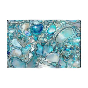 May include: Abstract blue and white marble pattern with a swirling, organic design. The pattern resembles a close-up of a rock or stone.