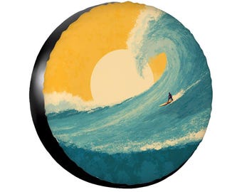 May include: A round, black object featuring a stylized illustration of a surfer riding a large ocean wave. The wave is depicted in shades of blue and white, with a yellow sun setting in the background. The surfer is a small silhouette.