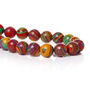 May include: A strand of colorful, round beads. The beads feature a swirling pattern of red, green, yellow, purple, and orange. The beads are strung together, creating a necklace or bracelet.