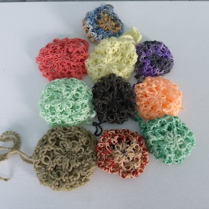 May include: A collection of 10 crocheted flower-shaped pouches in various colors, including green, red, orange, yellow, purple, and brown. The pouches are made with a delicate, lacy stitch and have a drawstring closure.