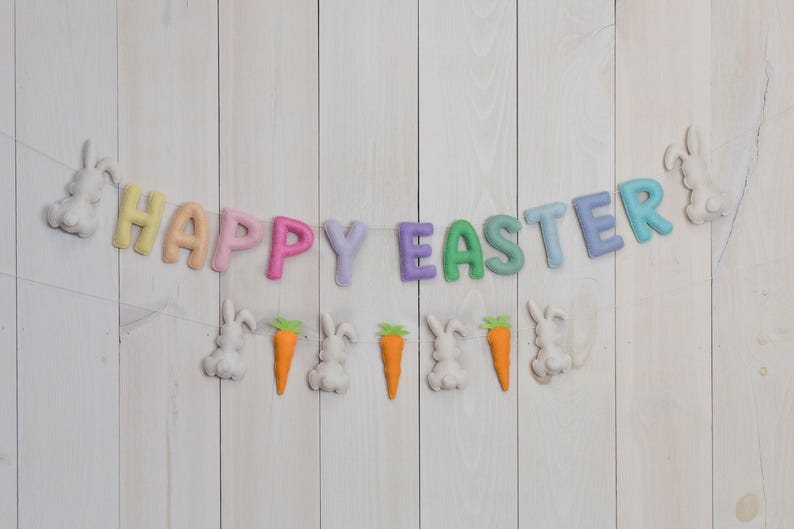 May include: A pastel-colored felt banner with the words "Happy Easter" and bunny and carrot decorations.