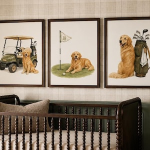 May include: A dark brown wooden crib with spindle-style railings and a beige mattress, positioned below three framed wall art prints. Each print features a golden retriever dog in a golf setting, including a golf cart, a flag, and a golf bag.