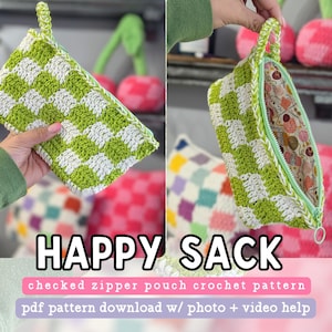 May include: A green and white crocheted zipper pouch with a checkered pattern. The pouch is open and the lining is visible. The text "HAPPY SACK" is written in large letters below the pouch. The text "checked zipper pouch crochet pattern" is written in smaller letters below the pouch. The text "pdf pattern download w/ photo + video help" is written in even smaller letters below the pouch.
