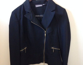 May include: A black blazer with a zipper closure and gold accents. The blazer has a collar and long sleeves.