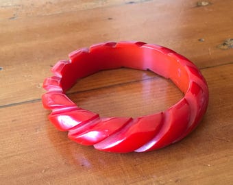 Carved tomato red bakelite bangle