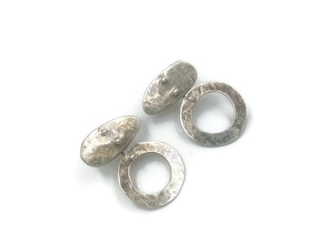 Sterling silver pebble hoop studs.