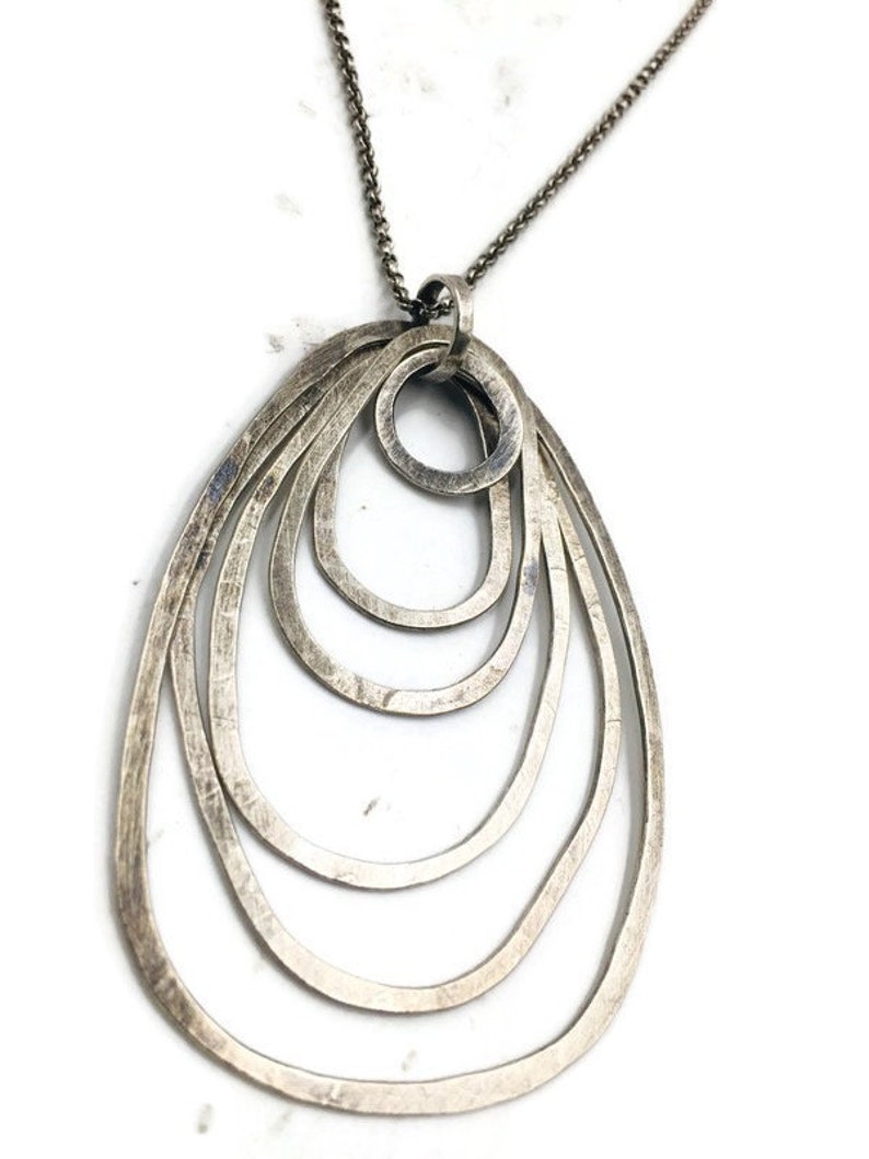 Sterling silver overlapping loops pendant on chain. Etsy