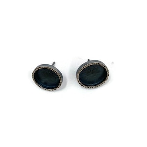 Sterling silver frame stud earrings.