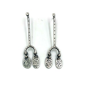 Long riveted pebble stud earrings.