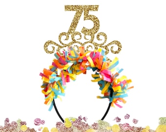 May include: Gold glitter headband with a number 75 and a decorative swirl design. The headband is decorated with colorful streamers.
