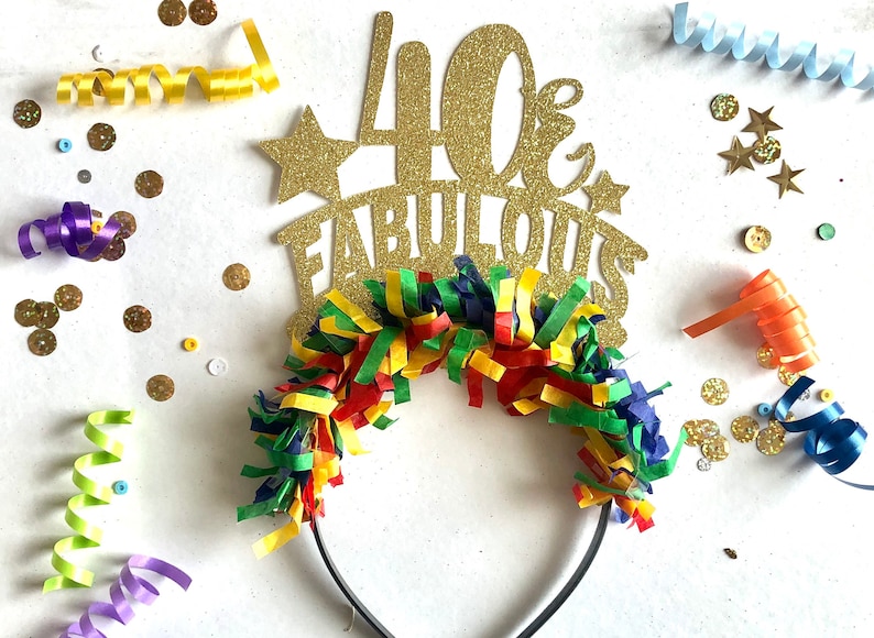 May include: Gold glitter headband with the text "40 & Fabulous" and colorful streamers.