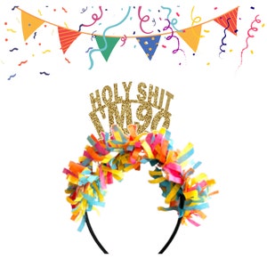 May include: A gold glitter headband with the text "HOLY SHIT I'M 90" on top. The headband is decorated with colourful streamers.