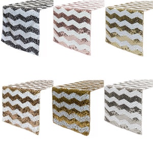 May include: Set of six table runners with a chevron pattern made of sequins. The runners are available in black and white, gold and white, rose gold and white, silver and white, and two shades of gold and white.