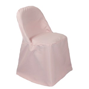 May include: A light pink chair cover for a folding chair. The cover is made of a smooth fabric and has a simple design.