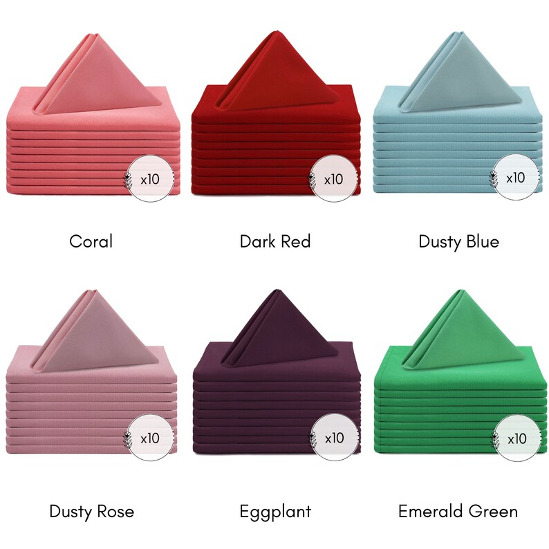 May include: Set of 10 dinner napkins in six different colours: coral, dark red, dusty blue, dusty rose, eggplant, and emerald green. Each napkin is folded into a triangular shape and stacked on top of each other.