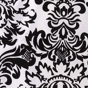 May include: Black and white damask pattern fabric with a repeating floral design.