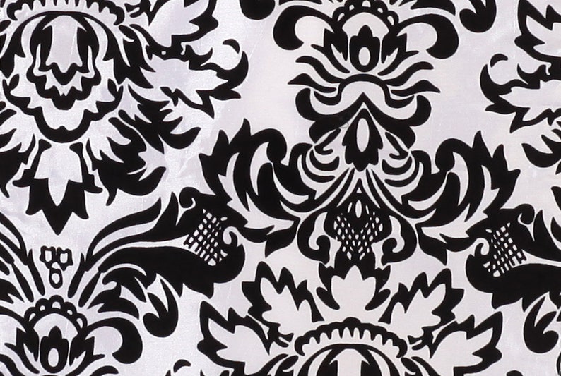 May include: Black and white damask pattern fabric with a repeating floral design.